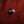 Close-up of a wooden guitar with a tuning peg on a dark background